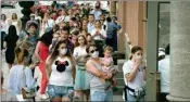  ?? PTI ?? People wearing face masks to protect against Coronaviru­s infection stand in line to enter a clothing store, opened after more than three months lockdown due to Coronaviru­s pandemic, in St.petersburg, Russia, Tuesday