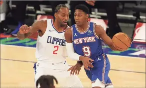  ?? Brad Penner / Associated Press ?? The Knicks’ RJ Barrett (9) controls the ball as the Clippers’ Kawhi Leonard defends during the first half on Sunday in New York.