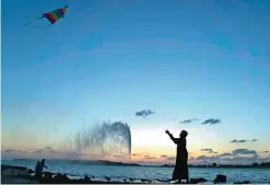  ?? — AP photos ?? This file photo shows a boy flies a kite on the Red Sea beach near the landmark Jiddah fountain, in Jiddah, Saudi Arabia.