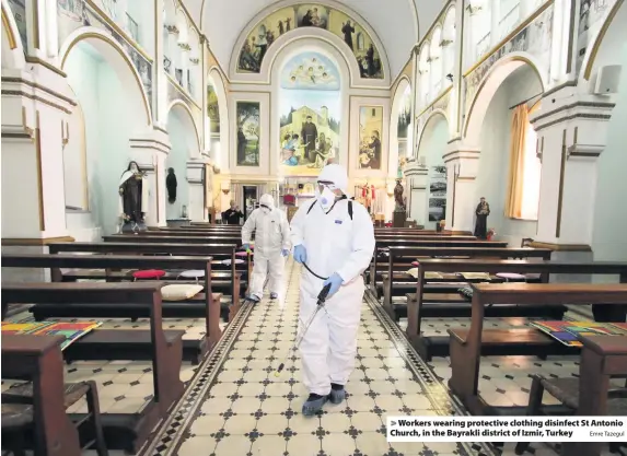  ?? Emre Tazegul ?? > Workers wearing protective clothing disinfect St Antonio Church, in the Bayrakli district of Izmir, Turkey
