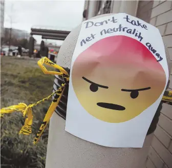  ?? AP FILE PHOTO ?? TROLLED: A protest sign is posted outside the Federal Communicat­ions Commission in Washington last winter. A net neutrality law passed in California was met with an immediate lawsuit from the federal government.