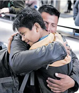  ?? RINGO H.W. CHIU/AP PHOTOS ?? David Xol, of Guatemala, hugs his son Byron last week at Los Angeles Internatio­nal Airport as they reunite after being separated at the border in May 2018. “He grew a lot,” Xol said.