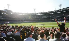  ??  ?? The crowd cheers at the 2019 AFL grand final between the Richmond Tigers and the GWS Giants at the MCG in Melbourne, Victoria. Photograph: Michael Dodge/AAP