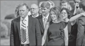  ?? AP file photo/BRYAN WOOLSTON ?? Fred and Cindy Warmbier watch as their son Otto’s casket is placed in a hearse June 22, 2017, after his funeral in Wyoming, Ohio. The Warmbiers spoke out Friday after President Donald Trump’s comment this week that he takes North Korea’s leader Kim Jong Un “at his word” that he was unaware of alleged mistreatme­nt during their son’s 17 months of captivity.