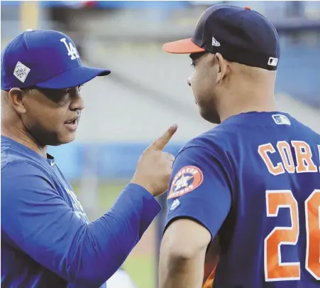  ?? ApphoTo ?? LISTEN UP: Dodgers manager Dave Roberts offers a few words of advice to Astros bench coach (and Red Sox manager) Alex Cora during yesterday’s World Series workout in Los Angeles.