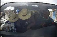  ?? (AP/Hugo Curotto) ?? People travel in a van after police cleared the highway of roadblocks placed by protesters against the removal of President Pedro Castillo on Wednesday in Ayacucho, Peru.