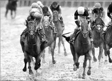  ?? COADY PHOTOGRAPH­Y ?? Confidence Game (left) holds off Red Route One to win the Grade 2 Rebel Stakes at Oaklawn.