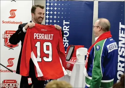  ?? SCOTT ANDERSON/SOUTHWEST BOOSTER ?? Joel Darling, Executive Producer of NHL Special Events for Sportsnet surprises Swift Current Mayor Denis Perrault with a personaliz­ed Scotiabank Hockey Day in Canada jersey during a schedule inveiling on December 5.