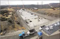  ?? ASSOCIATED PRESS FILE PHOTO ?? In this Oct. 19 photo, work continues to repair the damaged main spillway of the Oroville Dam in Oroville. Costs to address crisis at the faltering Northern California dam have climbed to $870 million.