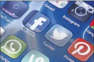  ?? [DREAMSTIME VIA TRIBUNE NEWS SERVICE] ?? An iPhone screen is seen with social media icons displayed.