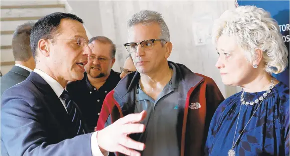  ?? KEITH SRAKOCIC/AP ?? Pennsylvan­ia Attorney General Josh Shapiro, left, talks with Cindy and Bernie Leech, whose son, Corey, testified before a state grand jury that he was sexually abused by Stephen Baker at Bishop McCort High School. Corey Leech, 31, who struggled with substance abuse, was found dead in his apartment in May 2017.