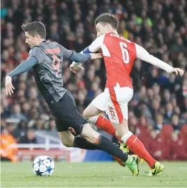  ?? Picture: Reuters ?? D(R)IVING FORCE. Bayern Munich’s Robert Lewandowsk­i goes down spectacula­rly, earning Arsenal’s Laurent Koscielny a red card in the process during their Champions League clash at the Emirates last night.