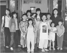  ??  ?? How (centre, back row) with a group of children in Kuching during a camp event in 2005.