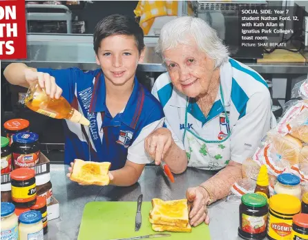  ?? Picture: SHAE BEPLATE ?? SOCIAL SIDE: Year 7 student Nathan Ford, 12, with Kath Allan in Ignatius Park College’s toast room.