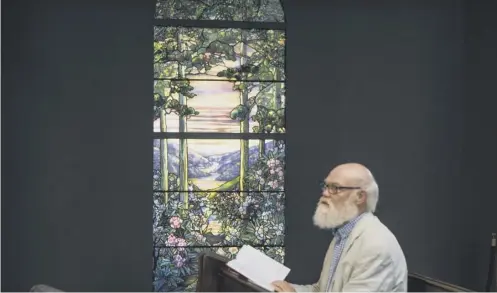  ?? PICTURE; SWNS ?? 0 Christophe­r Gorman, a visitor to Dunfermlin­e Abbey, reads by Andrew Carnegie’s window