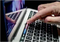  ?? AP ?? Higher-end models of Apple’s MacBook Pro now come with a narrow touch screen above the regular keyboard. —