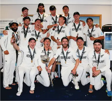  ?? Photo / Photosport ?? Captain Kane Williamson (centre with gold mace) and the Black Caps celebrate being world champions.