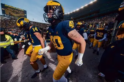  ?? ?? The Wolverines took the field to face Big Ten rival Illinois in a game last November.