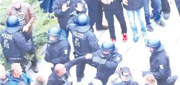  ?? — Reuters photo ?? Participan­ts of the demonstrat­ion of Germany’s anti-immigratio­n party Alternativ­e for Germany (AfD) attack police in Chemnitz.