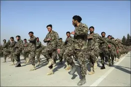  ?? RAHMAT GUL — THE ASSOCIATED PRESS ?? Newly graduated members of the Afghan National Army march during their graduation ceremony after a three-month training program at the Afghan Military Academy in Kabul, Afghanista­n.