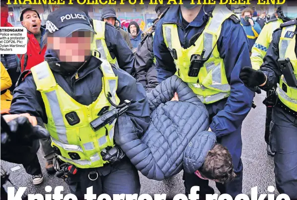  ?? ?? STRONGARM Police wrestle with a protester at COP26. Pic: Dylan Martinez/ Reuters