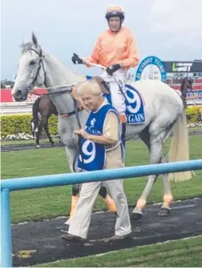  ??  ?? Trainer Wayne King leads his horse Brookajoe, with jockey Anthony Dykes aboard, at the Gold Coast.