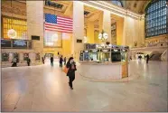  ?? MARK LENNIHAN/AP PHOTO ?? Commuters pass through Grand Central Terminal during the morning rush hour Monday.