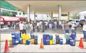  ?? ?? Sri Lankans gather at a fuel pump with empty containers to buy diesel in Colombo on Thursday.