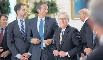  ?? JABIN BOTSFORD/THE WASHINGTON POST ?? GOP senators continue to hammer away at at heath care draft Thursday. From left, Sens. Tom Cotton, John Thune and Mitch McConnell attend a meeting earlier this week with President Donald Trump in the East Room of the White House.