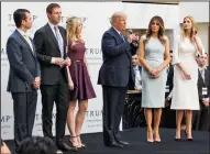  ?? CHERISS MAY/NURPHOTO FILE PHOTOGRAPH ?? Then-presidenti­al candidate Donald J. Trump, center, makes remarks with his family, from left: sons Donald Trump Jr., Eric Trump, daughter Tiffany Trump, his wife Melania Trump, and daughter Ivanka Trump, at Trump Internatio­nal Hotel on Oct. 26, 2016 in Washington, D.C. A New York attorney general has filed a civil lawsuit against President Trump, his kids, and their not-for-profit foundation.