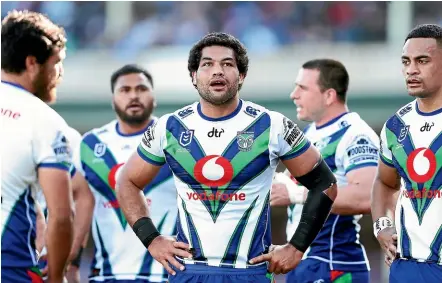  ?? GETTY IMAGES ?? Adam Blair and his Warriors team-mates look dejected during the hefty defeat to the Roosters.