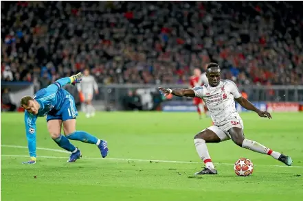  ?? GETTY IMAGES ?? Bayern goalkeeper Manuel Neuer is left flounderin­g as Sadio Mane coolly scores Liverpool’s first goal.