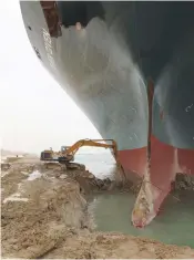  ?? (Suez Canal Authority/Reuters) ?? AN EXCAVATOR attempts to free ‘Ever Given,’ one of the world’s largest container ships, after it ran aground in the Suez Canal.