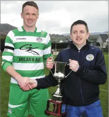  ??  ?? Newfoundwe­ll captain John Kermode is presented with the trophy by NEFL fixtures secretary Declan Jordan.