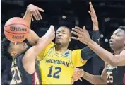  ?? Wally Skalij Los Angeles Times ?? MUHAMMAD-ALI ABDUR-RAHKMAN and Michigan survive a scrappy game with Florida State.