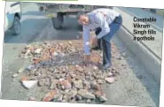  ??  ?? Constable Vikram Singh fills a pothole