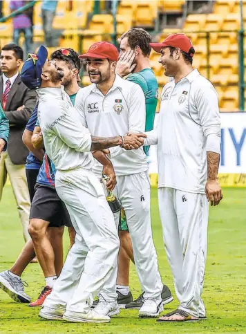  ?? PTI ?? Seeing through their guile: Shikhar Dhawan shares a light moment with Afghan spinners Rashid Khan and Mohammad Nabi after India’s victory. The duo was with Dhawan at Sunrisers Hyderabad in the IPL and the Indian opener dismantled their threat in next to no time in the Test.