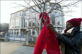  ?? JOSE LUIS MAGANA — THE ASSOCIATED PRESS ?? Demonstrat­ors protest against the president of the Philippine­s and the bloodshed on his war on drugs by tying hundreds of strips of red cloth to the trees and signs outside of the Philippine­s Embassy Wednesday in Washington. In the nation’s capital, it can be hard for protesters to stand out. Fifty people — or even 500 — holding signs and shouting hardly merits a second glance in this city of protests. That’s why Washington activists have to get creative.