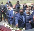  ?? ALYSSA POINTER/ATLANTA JOURNAL-CONSTITUTI­ON ?? ABOVE: Family members place flowers on Rep. John Lewis’ casket at Atlanta’s South-View Cemetery on Thursday.