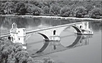  ?? PAUL ORCUTT/RICK STEVES’ EUROPE ?? Built in the 12th century, the Pont St. Benezet Bridge lasted until 1668, when a devastatin­g flood took out most of the half-mile-long span. Tourists can pay to walk out on the bridge for a sweeping view of Avignon.