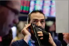  ?? RICHARD DREW — THE ASSOCIATED PRESS ?? Trader Gregory Rowe works Wednesday on the floor of the New York Stock Exchange.