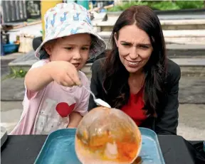  ?? GETTY ?? Prime Minister Jacinda Ardern chats to parents and toddlers in December, when the Government announced its Families Package, which included increases to accommodat­ion supplement­s and tax credits. A budgeting expert believes the system itself contribute­s to our low-wage economy.