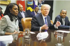  ?? Evan Vucci / Associated Press 2017 ?? Omarosa Manigault Newman (left) sits next to President Trump at a White House meeting last year during African American History Month.