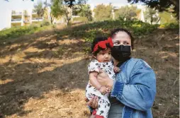  ??  ?? Rosa Baltobano, with her daughter Sofia, has lived in the neighborho­od since she was 6. She says the townhomes would take away open space.