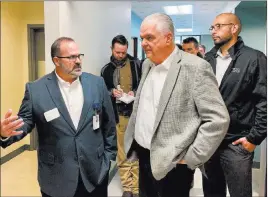  ?? Bill Dentzer ?? Las Vegas Review-journal Steve Sisolak, Democratic candidate for Nevada governor, center, gets a tour of the Community Health Alliance’s Reno facility from the alliance’s Joseph Mazzucotel­li on Monday. At right is Reno City Council member Oscar Delgado.