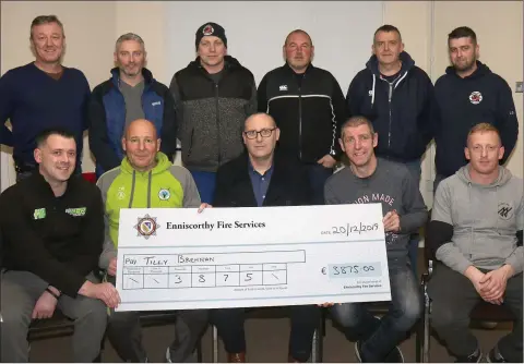  ??  ?? Enniscorth­y Fire Services cheque presentati­on of €3875 to Tilly Brennan family, proceeds of their Christmas Bucket Collection. Back.