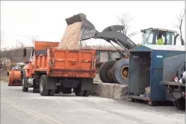  ?? Ned Gerard / Hearst Connecticu­t Media ?? A payloader fills a waiting truck with salt outside the Fairfield Department of Public Works garage Wednesday in preparatio­n for the snowstorm.