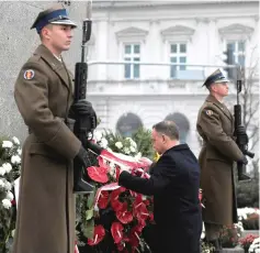  ??  ?? Duda, flanked by military guards, lays a wreath at the Wincenty Witos Monument at Three Crosses Square during the country’s 100th Independen­ce Day anniversar­y in Warsaw, Poland. — Reuters photo