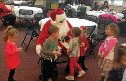  ?? BOB KEELER — DIGITAL FIRST MEDIA ?? Children gather around Santa at the Dec. 9 Breakfast with Santa to benefit this year’s Franconia Police Benevolent Associatio­n Shop with a Cop.