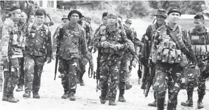  ?? (AFP) ?? SOLDIERS patrol a road in Pigcawayan, North Cotabato following an attack by Bangsamoro Islamic Freedom Fighters.